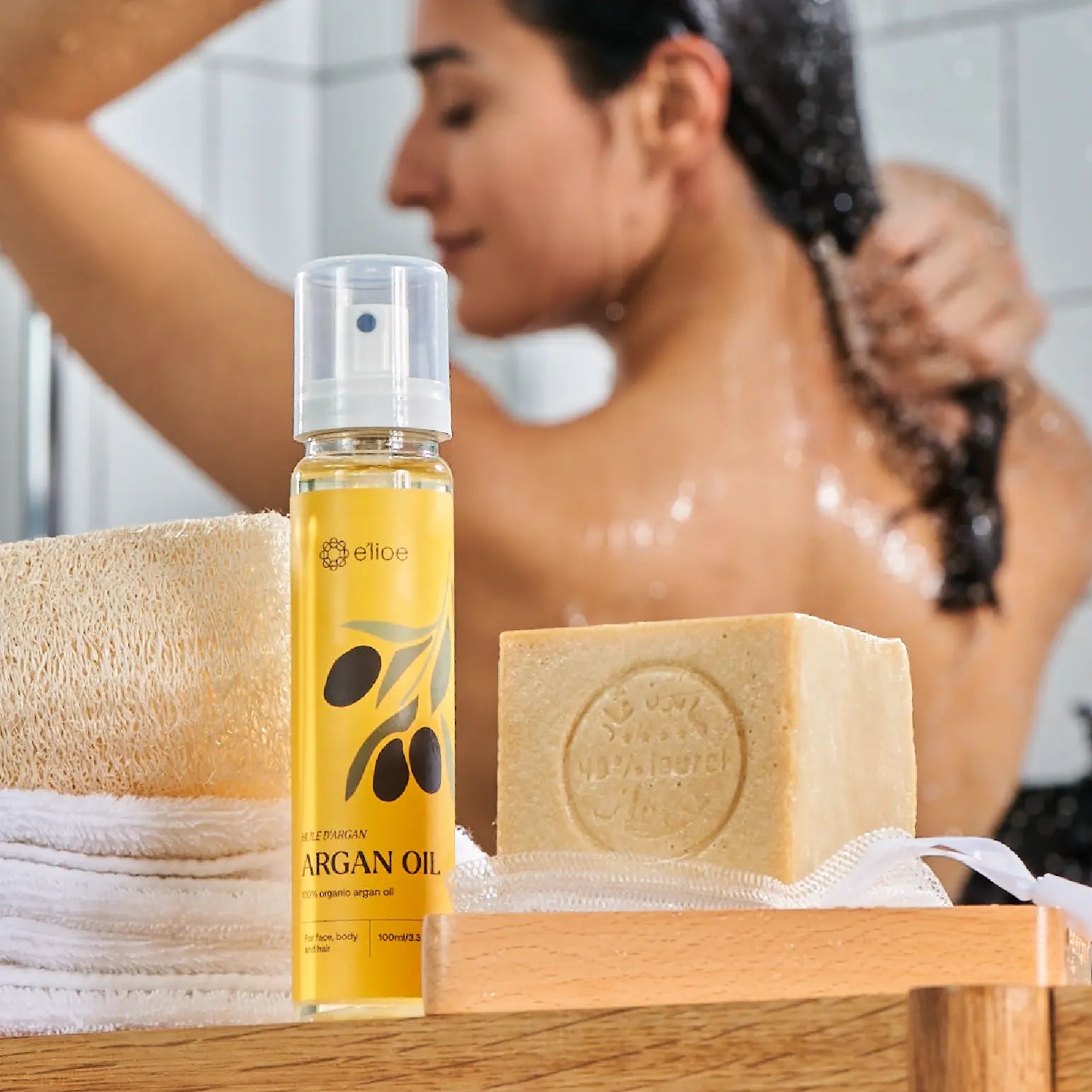 Pure argan oil bottle and a traditional aleppo soap bar, ideal natural skincare for acne-prone skin.